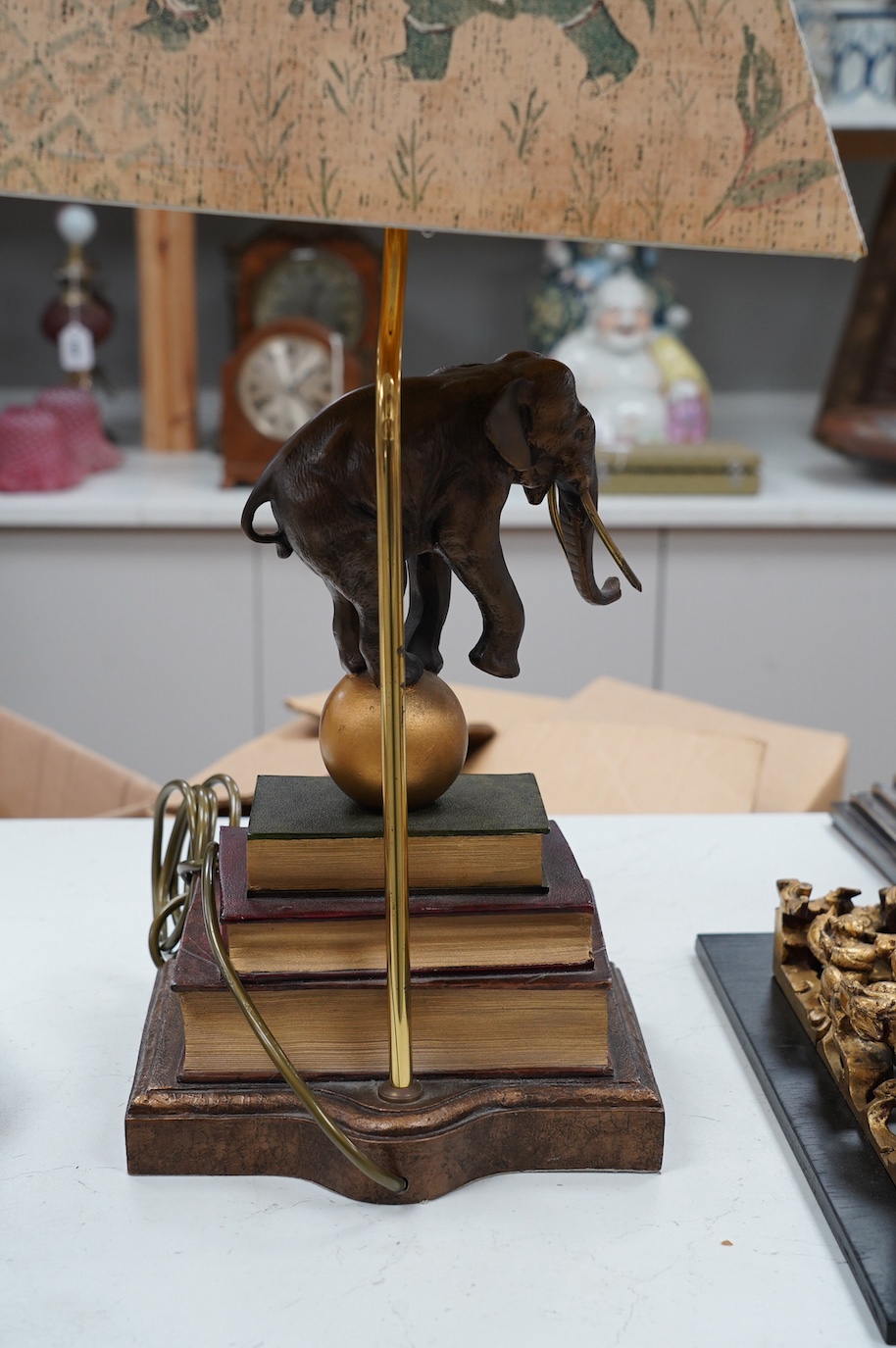 A Thomas Blakemore style ‘elephant’ and faux book table lamp with shade, 64cm. Condition - good, not tested as working